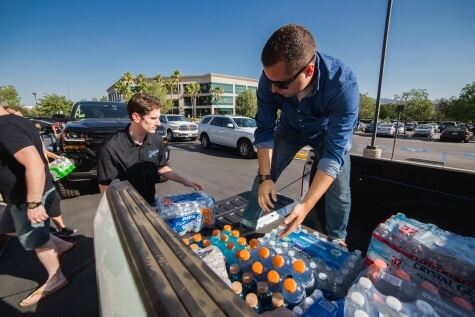 Scorpions passing out drinks from the back of a truck